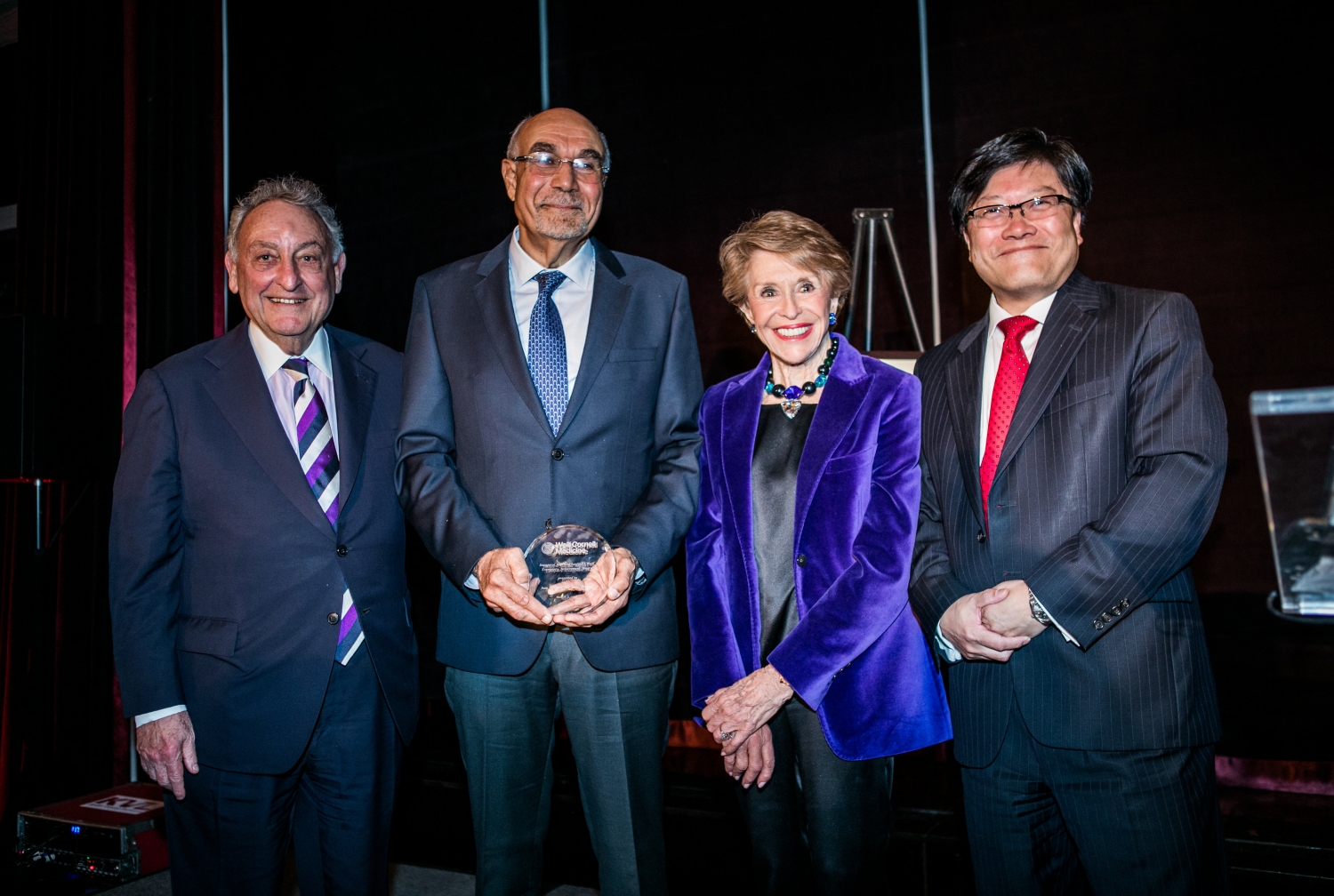 A group of people at an awards ceremony.